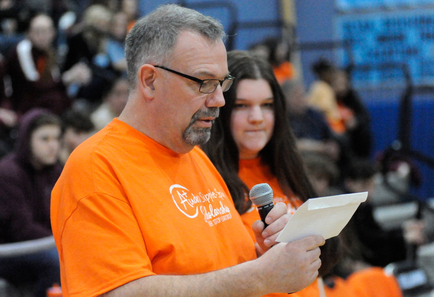 A moment of remembrance. John Spath addresses the packed gym, thanking the crowd for supporting the new Audra Sipple-Spath Scholarship Fund. He is pictured with his 21-year-old daughter Karlee, a 2019 graduate of Sullivan West.